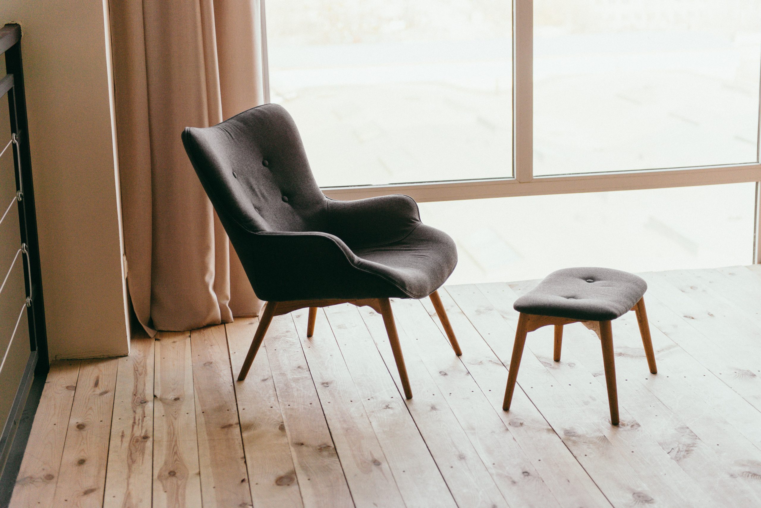 empty chair in the corner of a wood-floored room