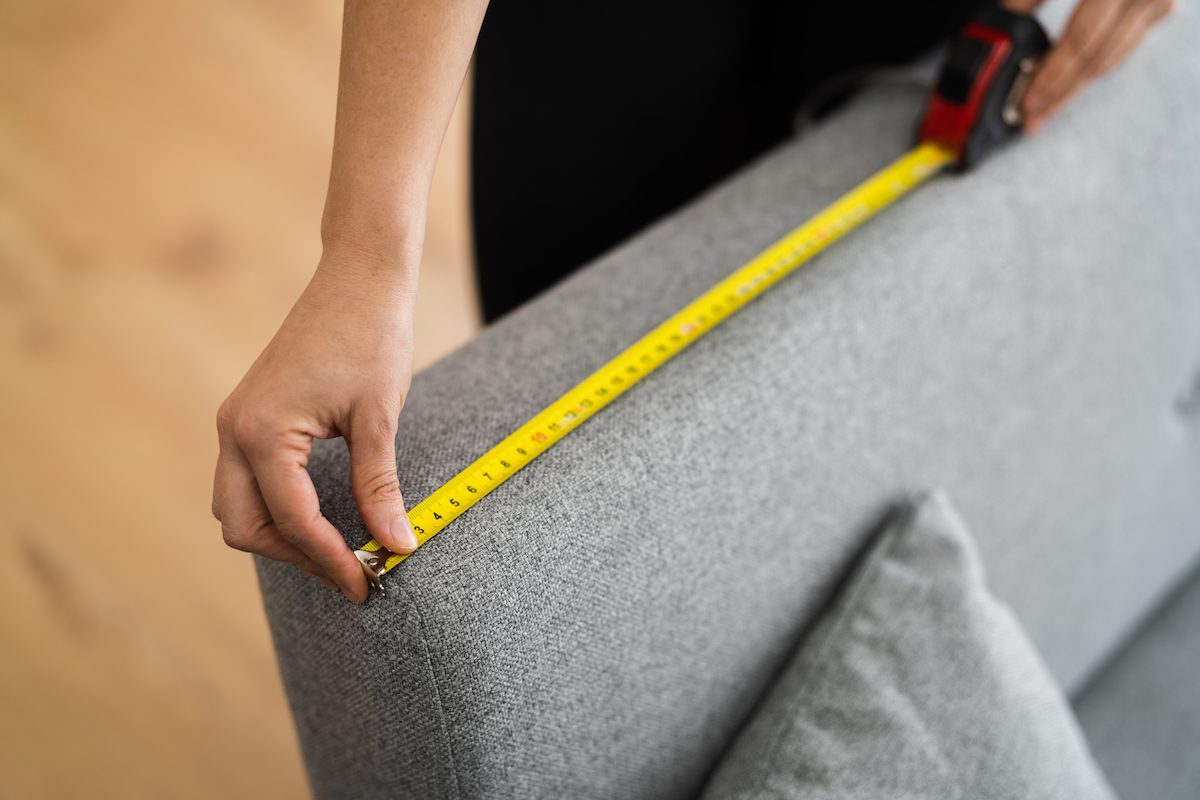 Man measuring the couch